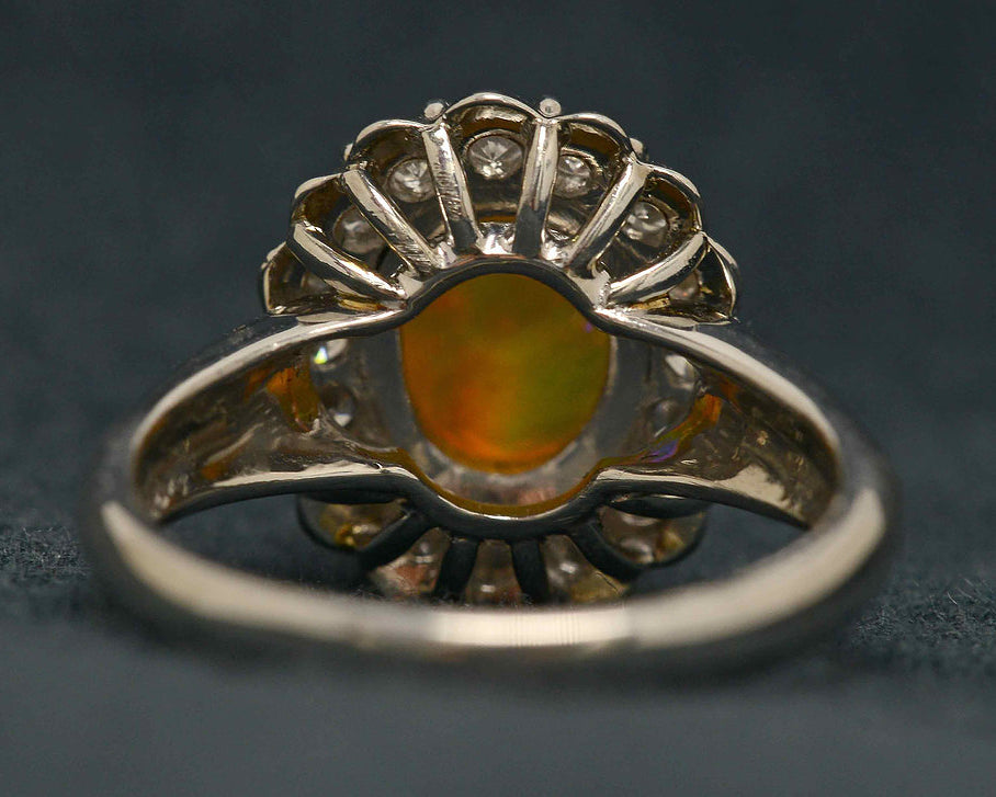 An Australian crystal jelly opal set in a platinum ring with diamonds.