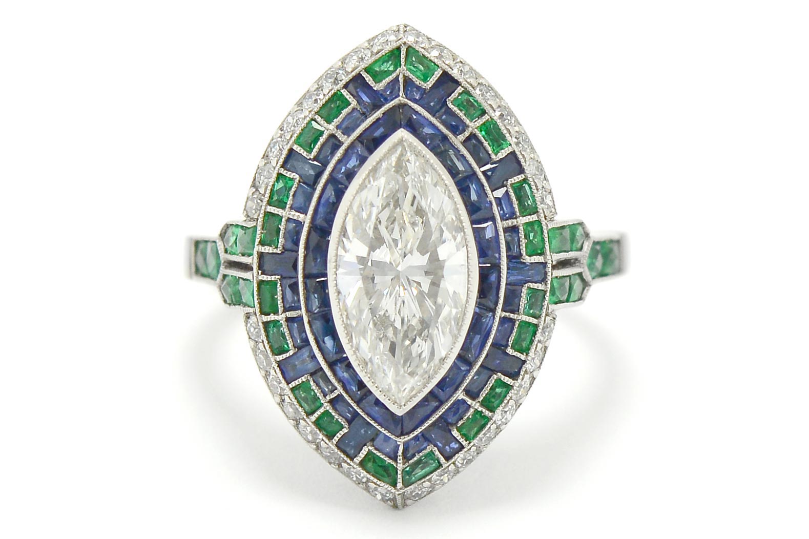 A 4 carat marquise cut diamond in a sapphire and emerald Art Deco mosaic engagement ring.