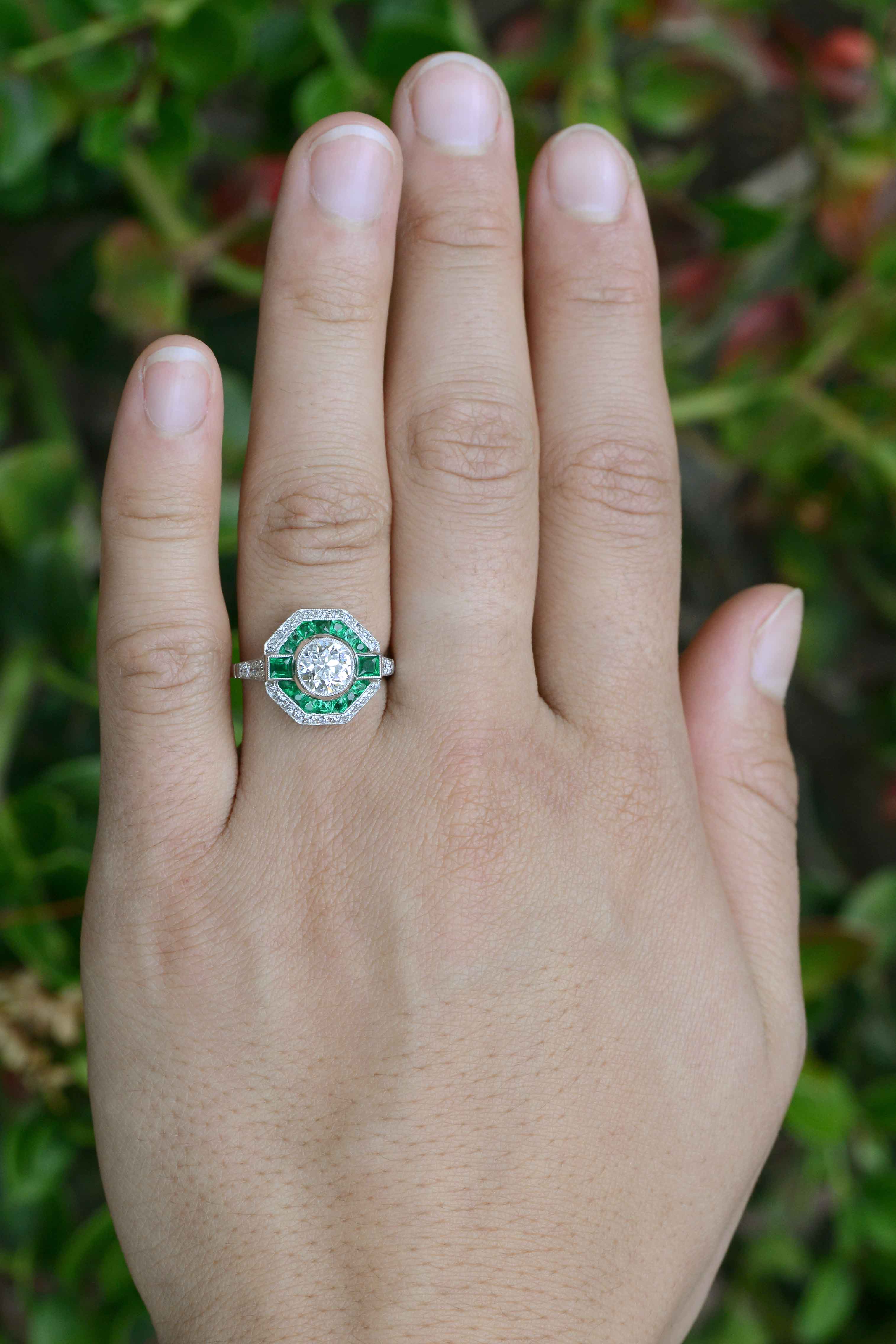 An octagon shape diamond wedding ring with an emerald halo.