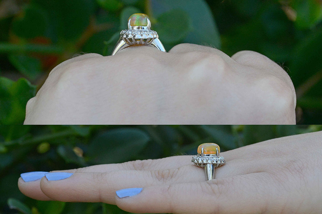 An oval cabochon opal dome ring with diamonds.