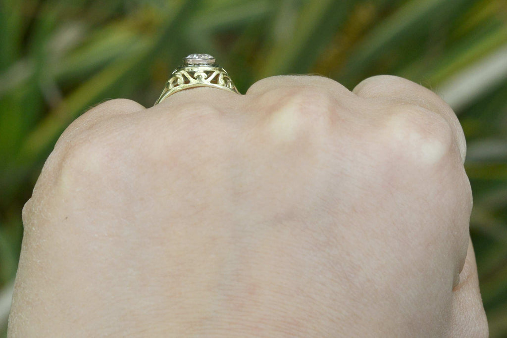 An i color and si2 clarity diamond set in unique filigree engagement ring.