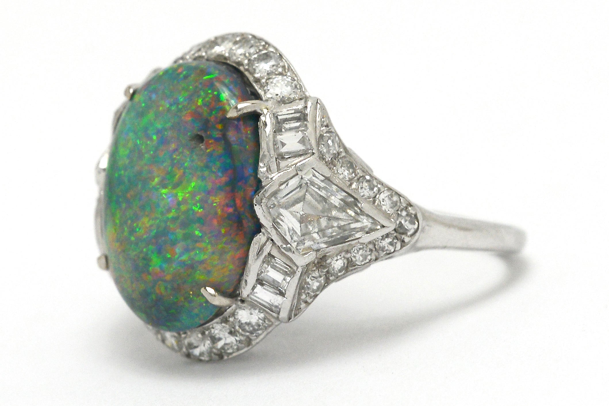 Dome black opal cocktail ring with kite and baguette diamonds.