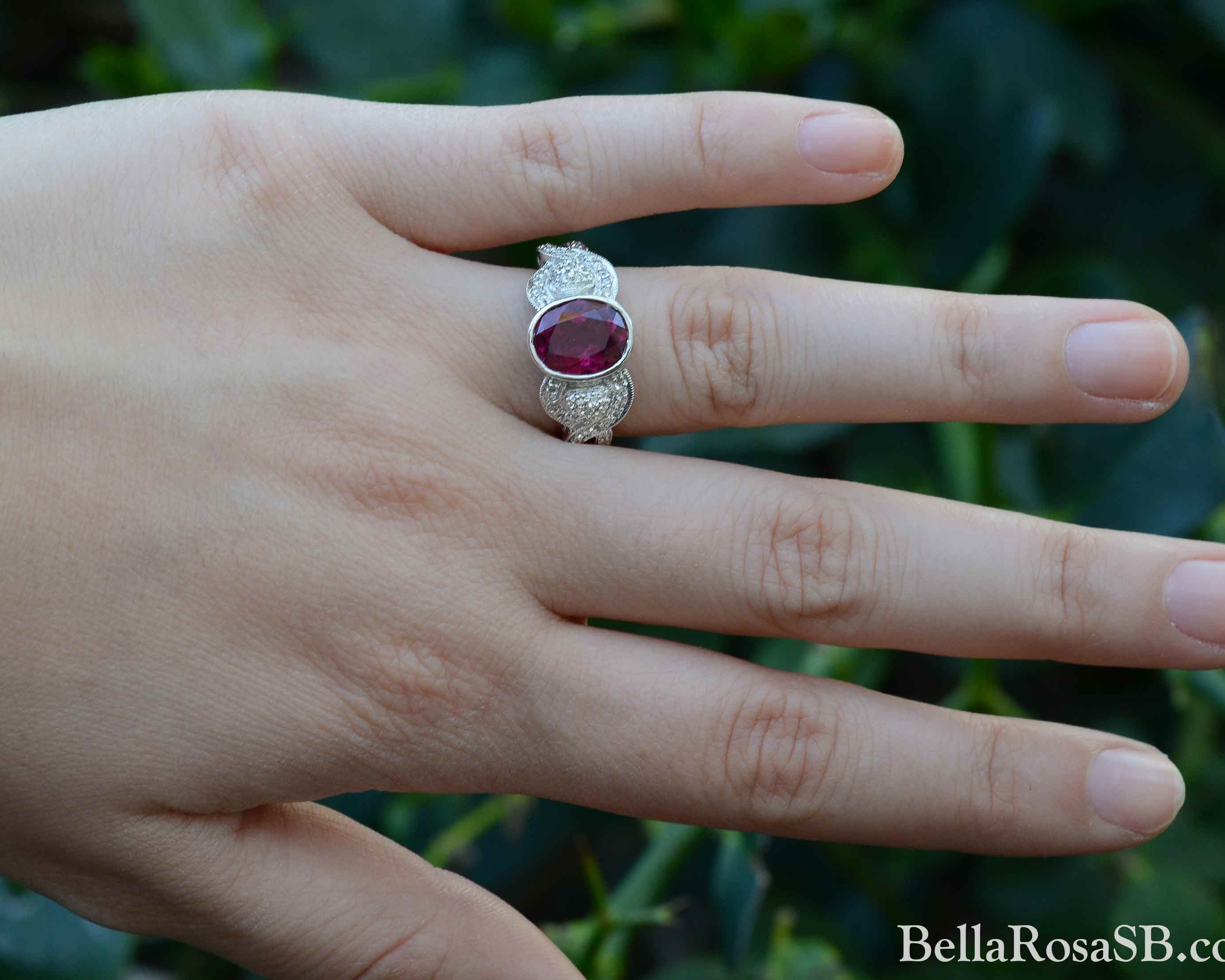 A retro purple red oval tourmaline engagement ring.