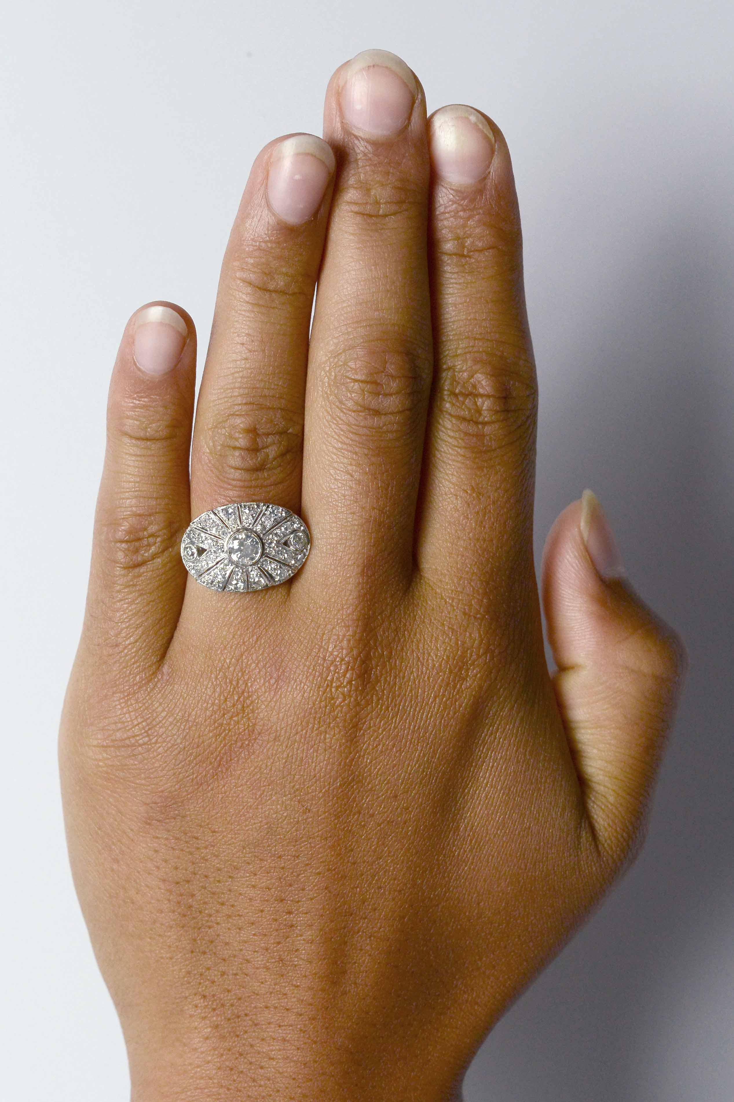 A third carat round brilliant diamond, oval shaped statement ring.