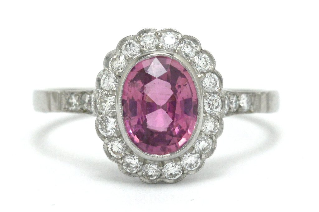 Art Deco style oval pink sapphire diamond halo engagement ring.