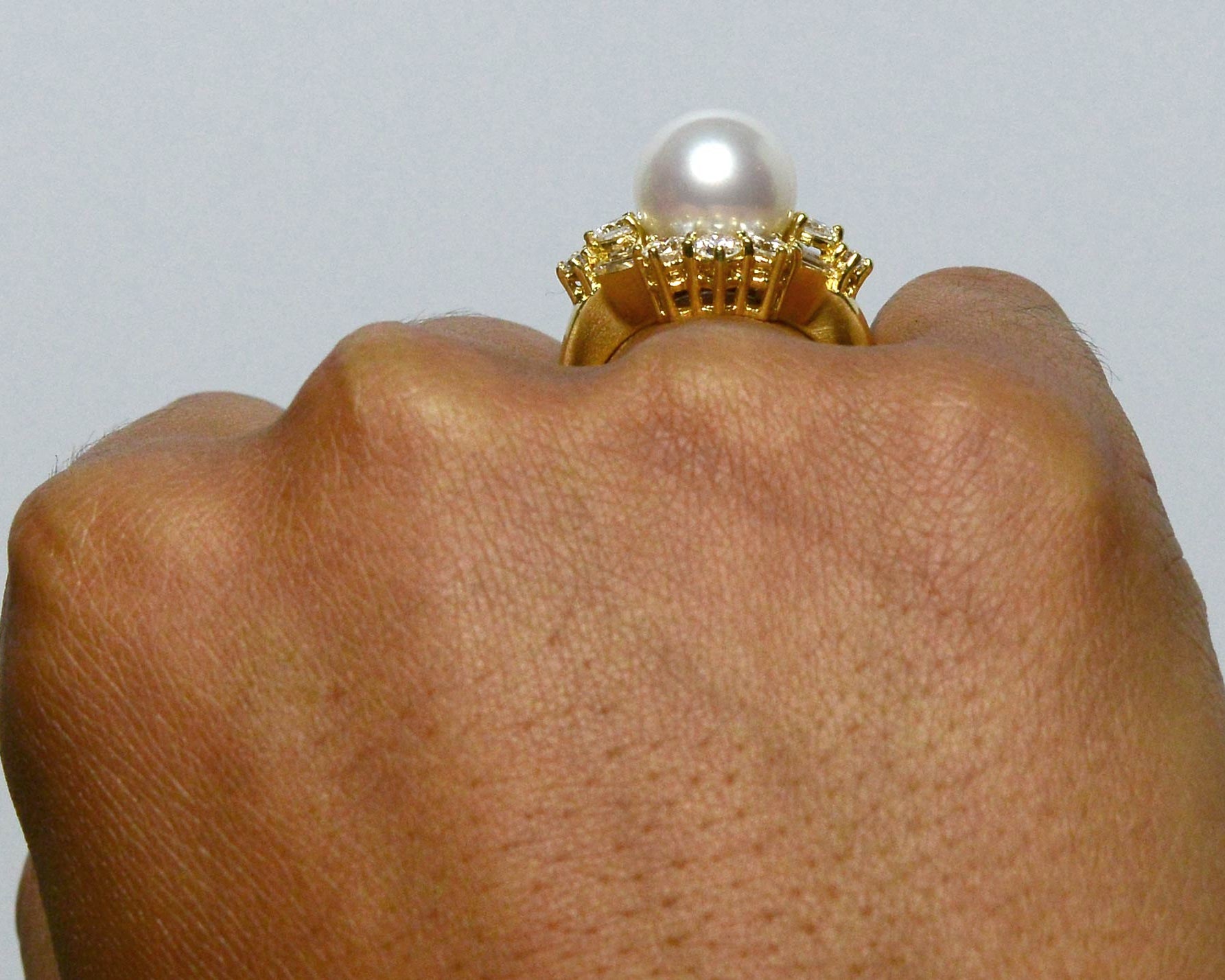 A round natural pearl gold dome cocktail ring.