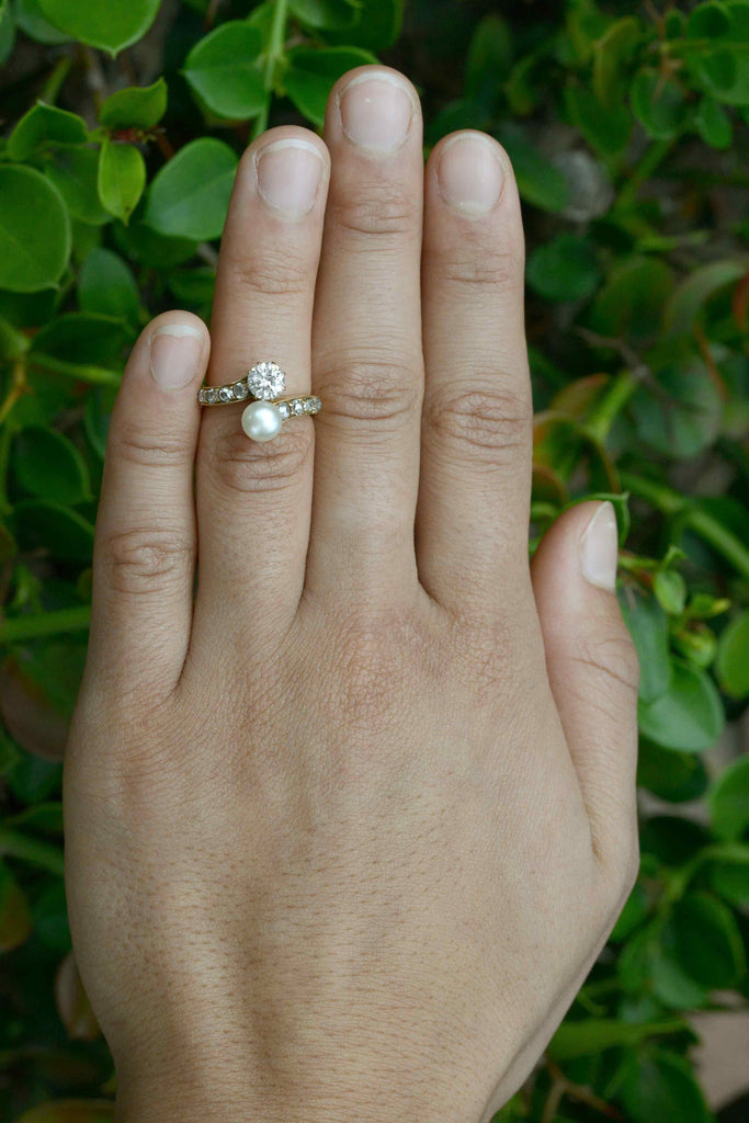 A diamond and pearl toi et moi 2 stone antique wedding ring.