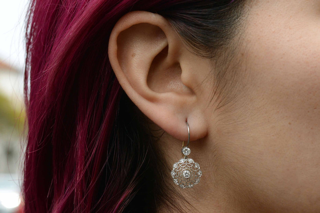 These diamond cluster earrings resemble a spider web.