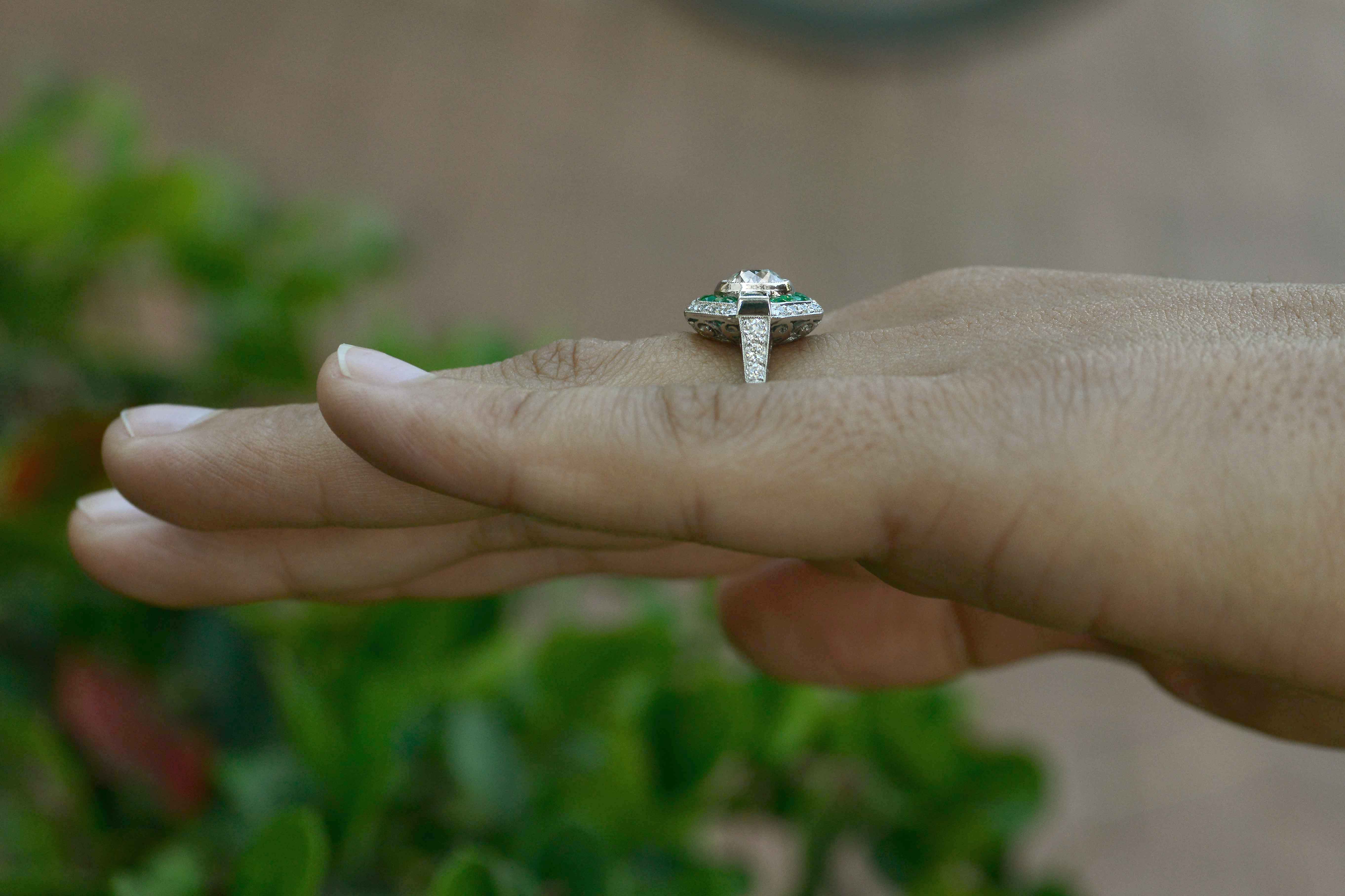 A unique geometric diamond emerald halo pattern wedding ring.
