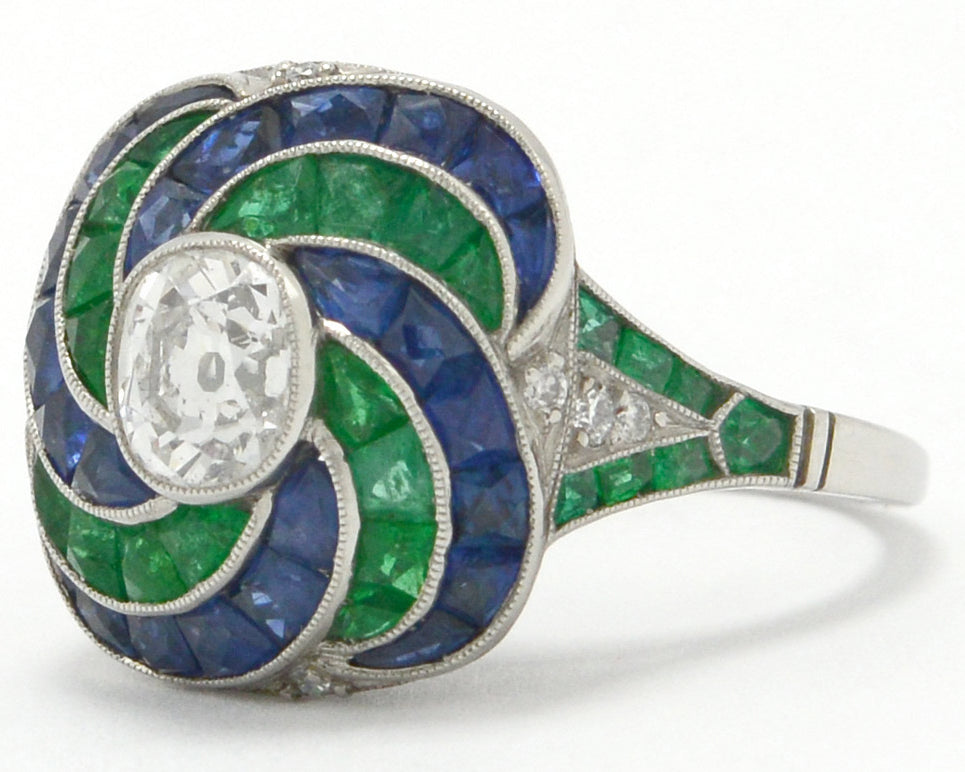 There is 4 carats of emeralds, sapphires and diamonds in this Art Deco revival wedding ring.