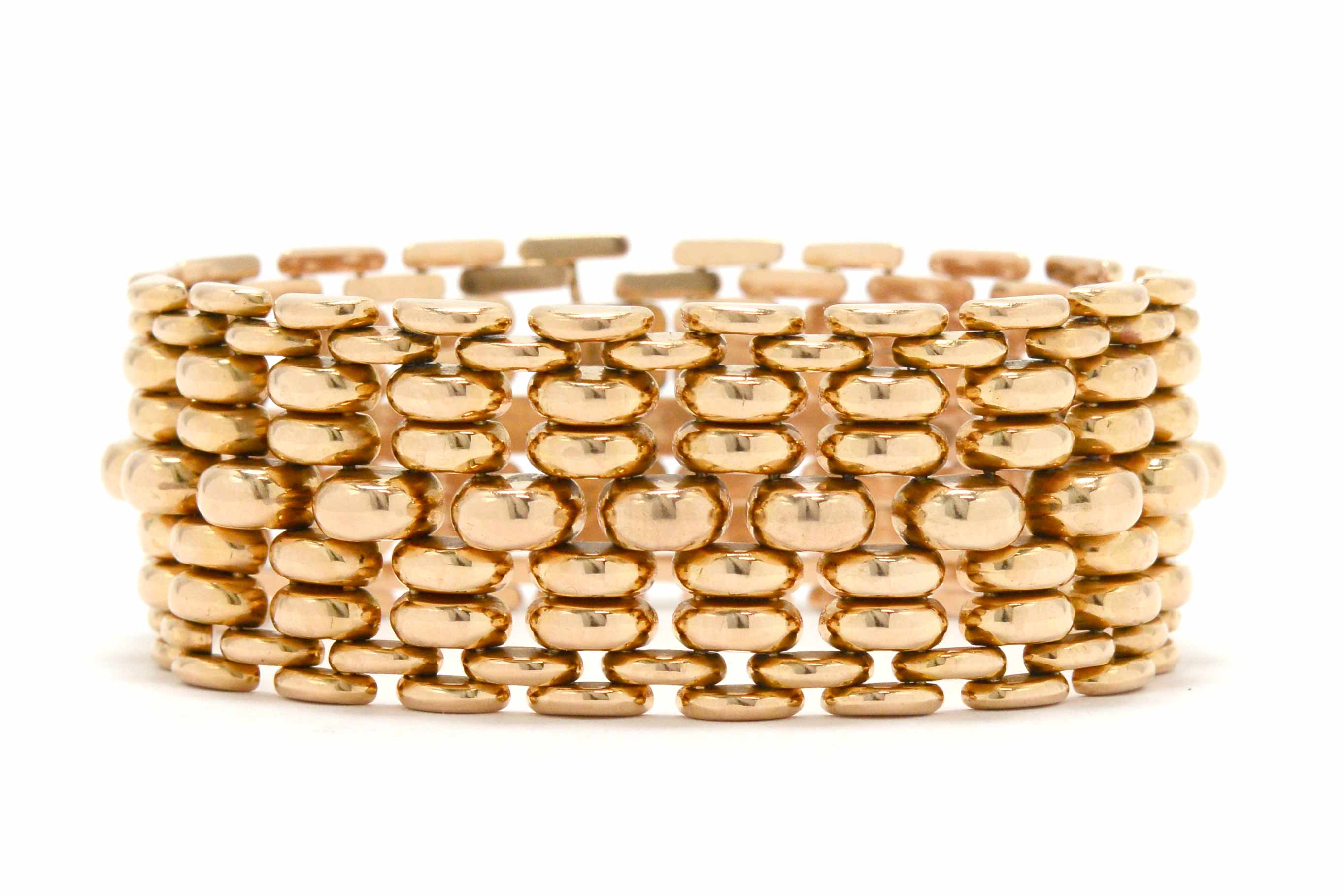An iconic rose gold woven link bracelet styled after WWII era tank treads.