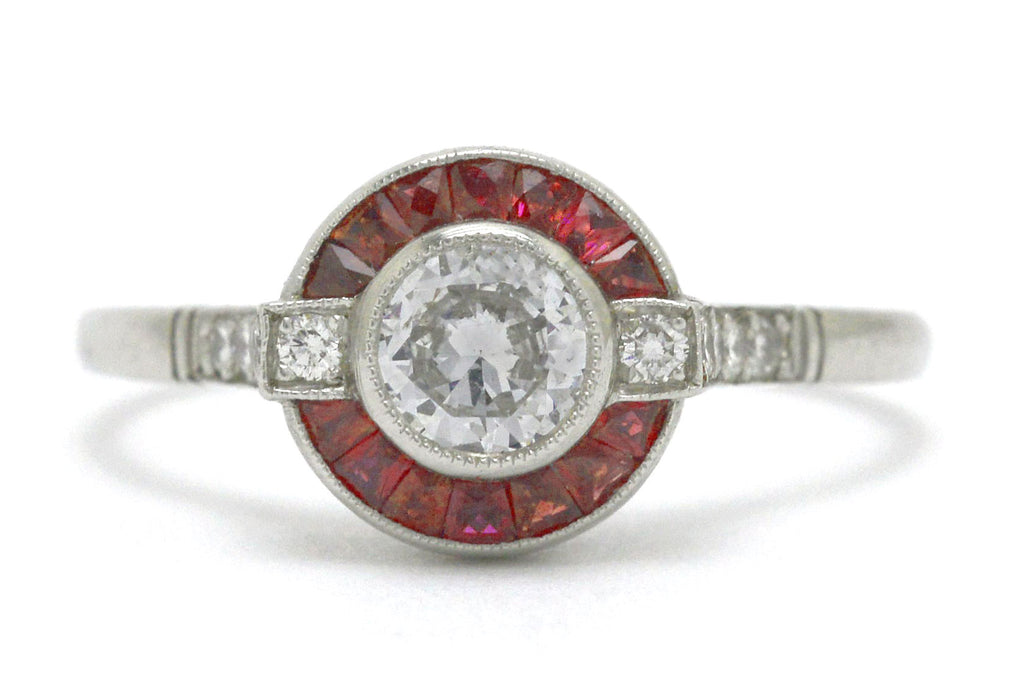 An Art Deco diamond ruby arch, halo engagement ring.