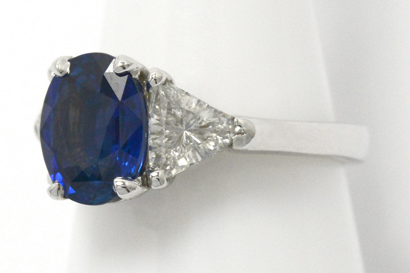 1.50 carats of trillion cut diamonds support this large ceylon sapphire engagement ring.