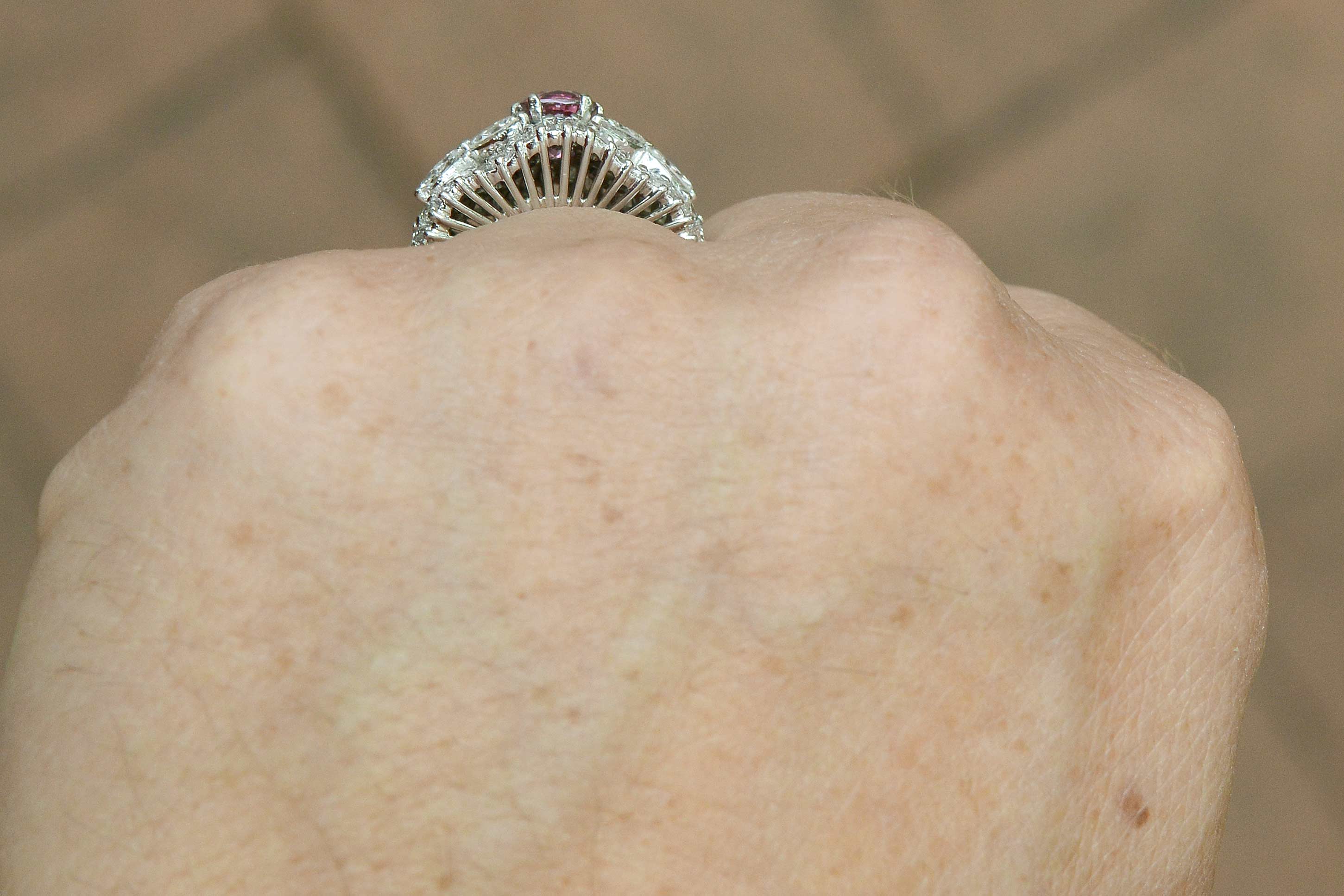 Baguette and marquise cut diamonds accent this mid century pink sapphire platinum ring.