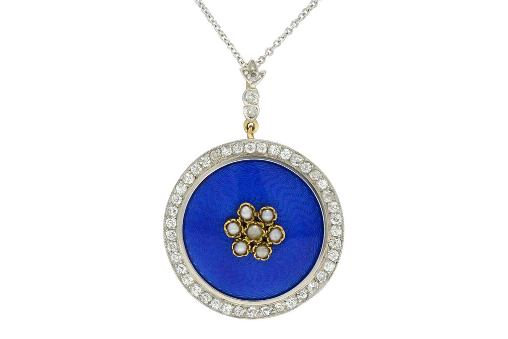This blue enamel pendant has a motif of dainty seed pearls and blue enamel.