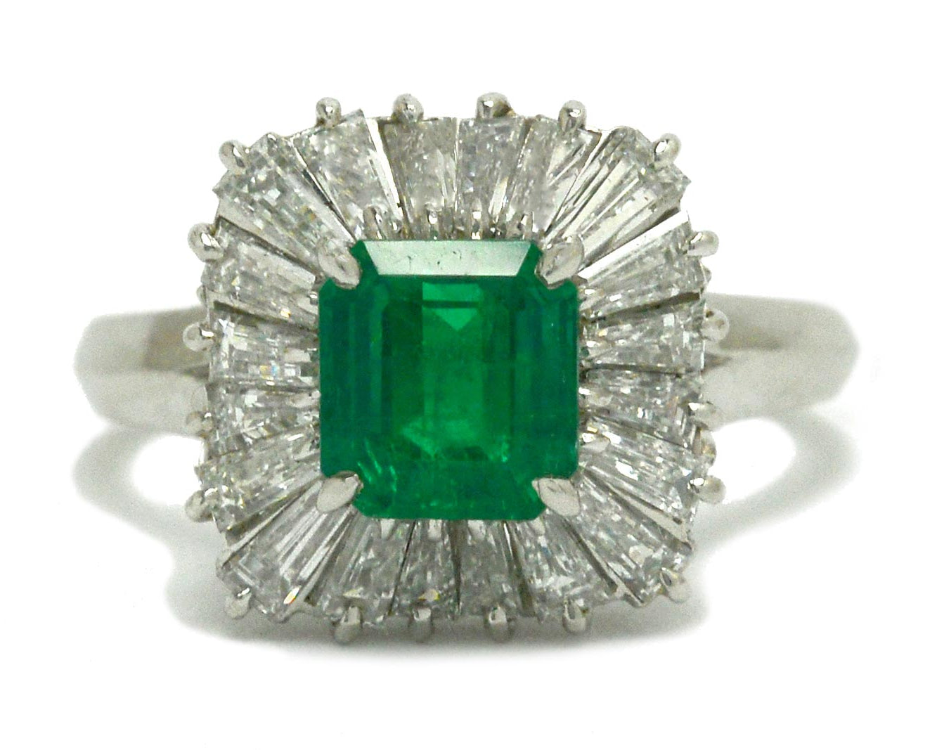 A mid-century 1960s emerald target ring, surrounded by diamonds.