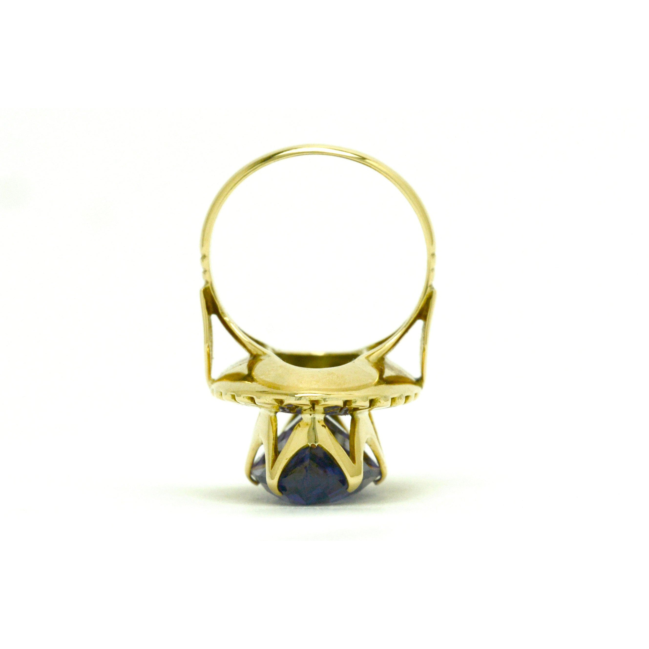 A tall gold retro cocktail ring with a marquise cut amethyst.