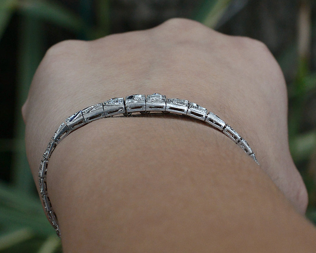 A tapered platinum diamonds bracelet.
