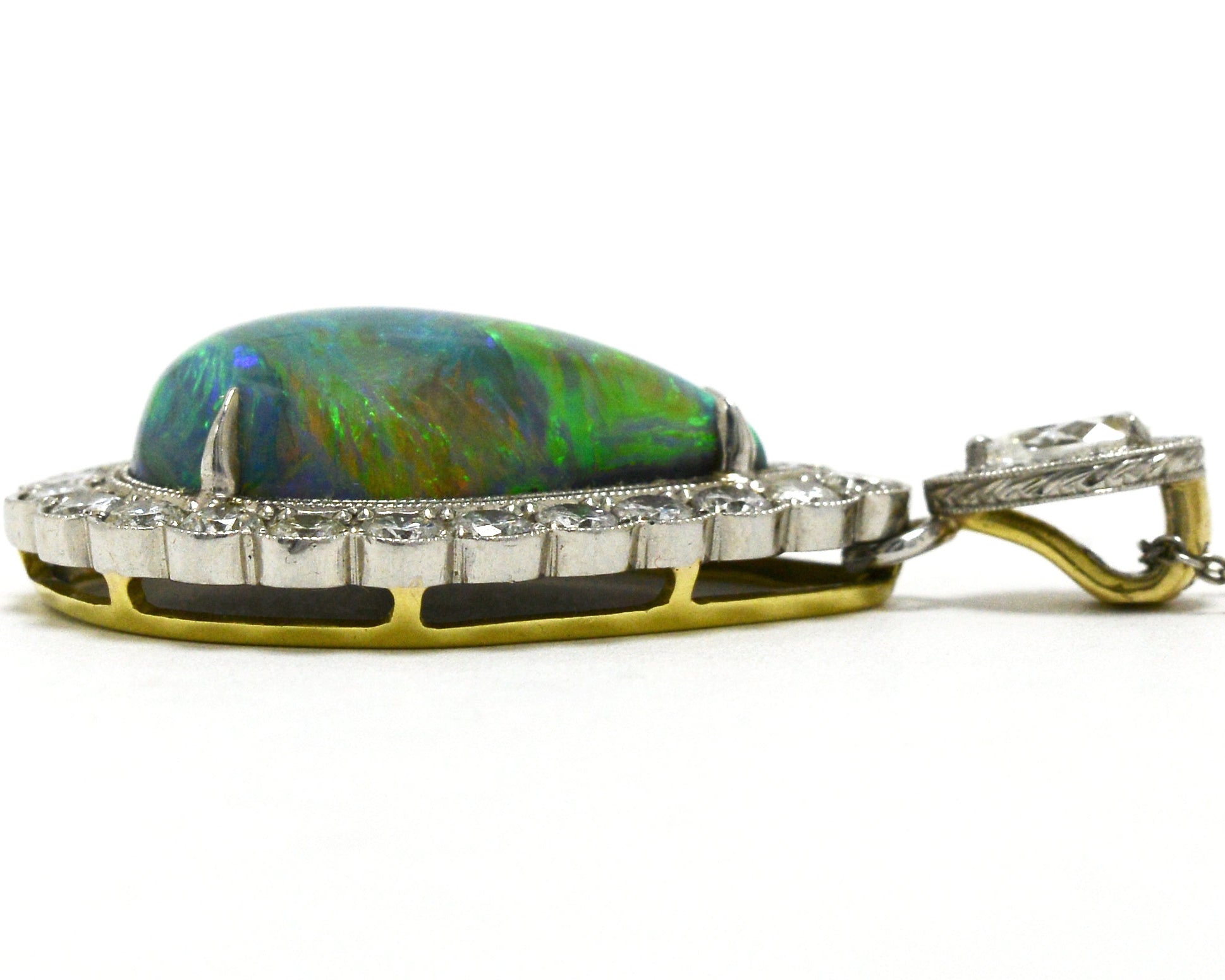 A platinum and gold cabochon black opal necklace with diamonds.