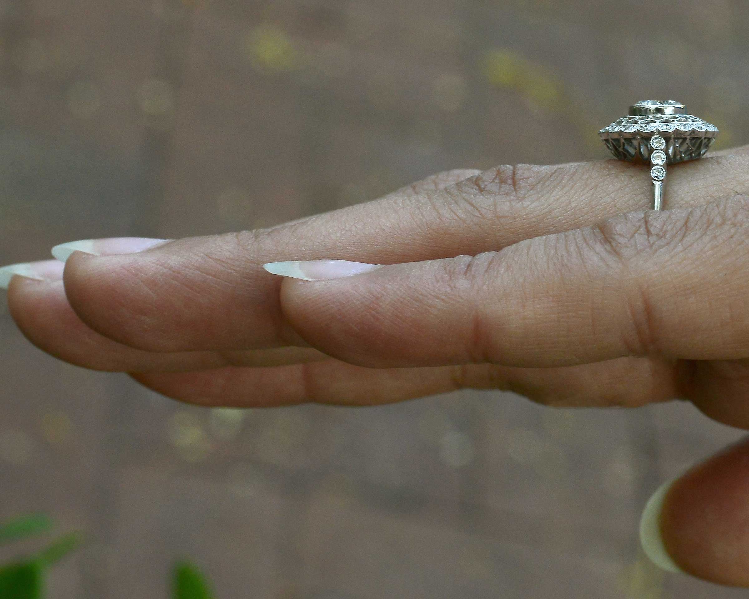 An Edwardian style laced halo diamond engagement ring.