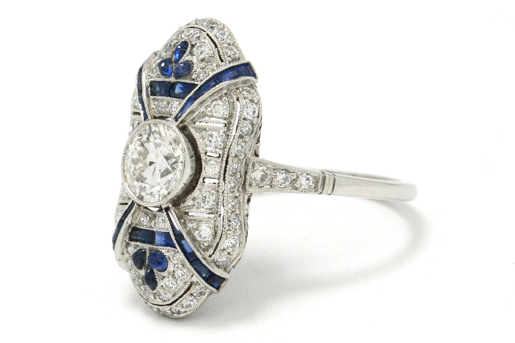 The 1 carat round diamond is accented by blue sapphires.
