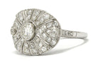 A radiating diamonds, oval shaped platinum antique statement ring.
