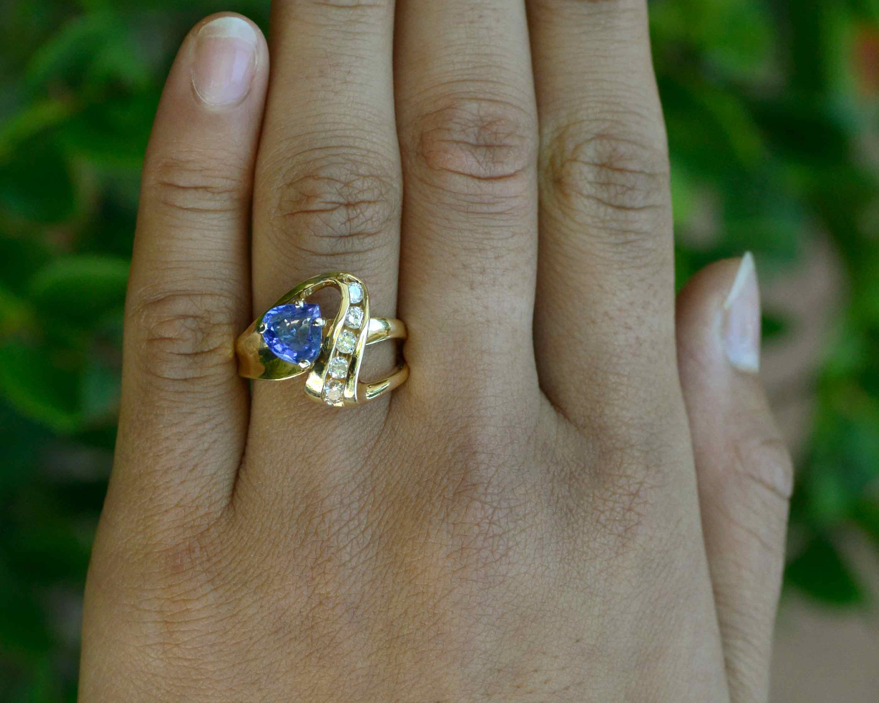 A natural triangle shape tanzanite and diamonds cocktail ring.