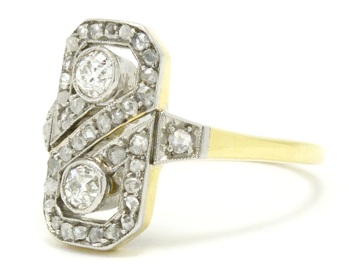 A platinum and gold 2 diamond figure 8 wedding ring design.