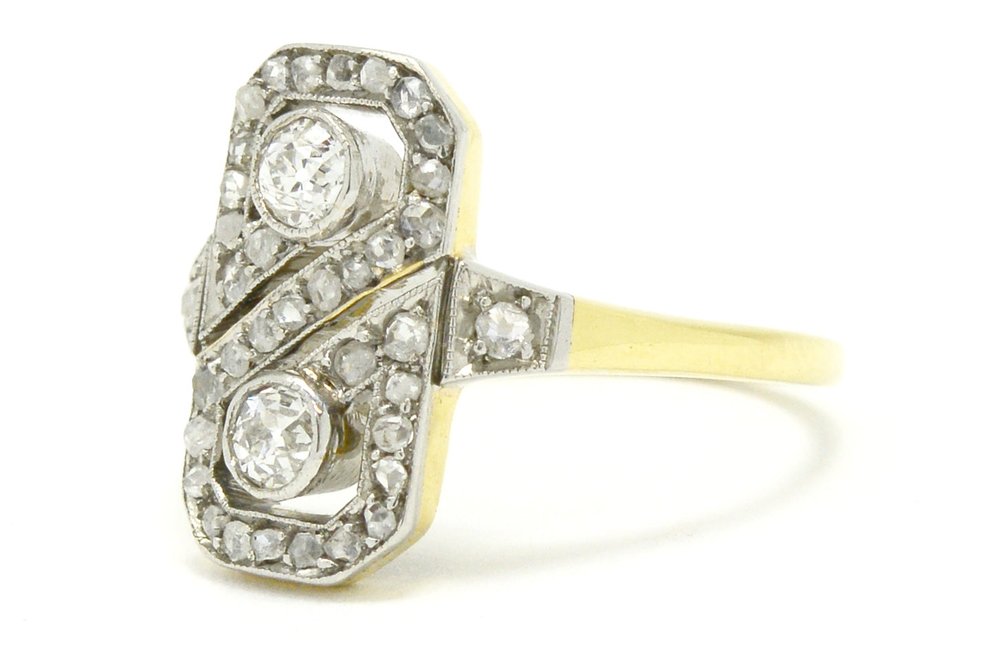 A platinum and gold 2 diamond figure 8 wedding ring design.