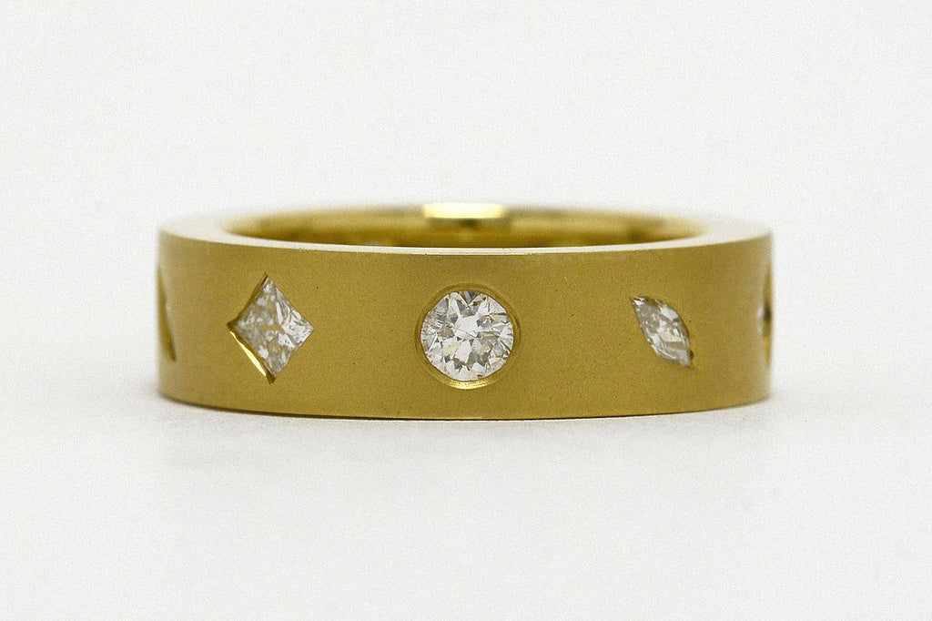 A modern anniverary band with marquise and princess cut diamonds.