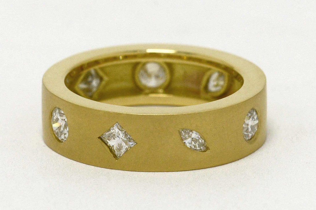 Marquise, princess and round cut diamonds in a modern comfort fit band.