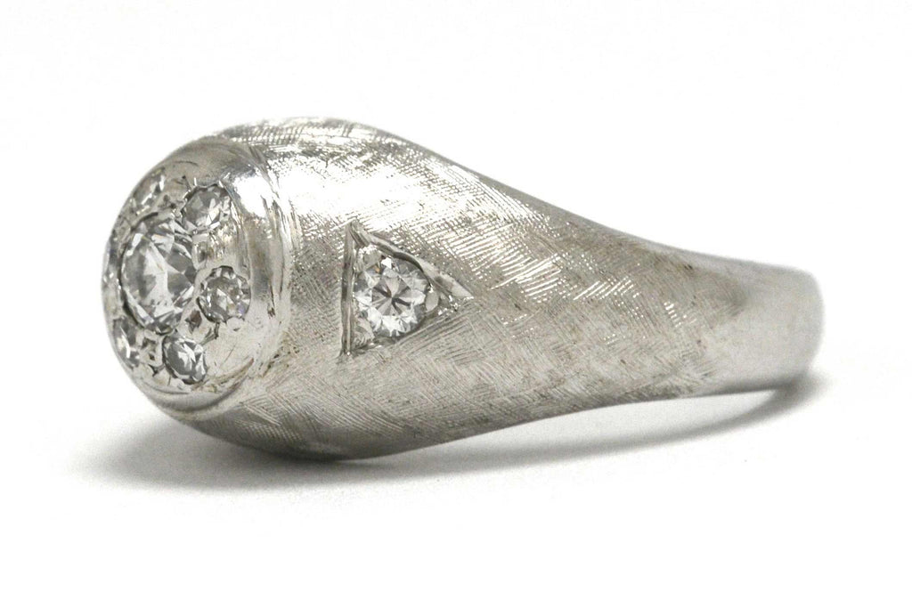 A men's white gold diamond gypsy ring with a brushed texture.