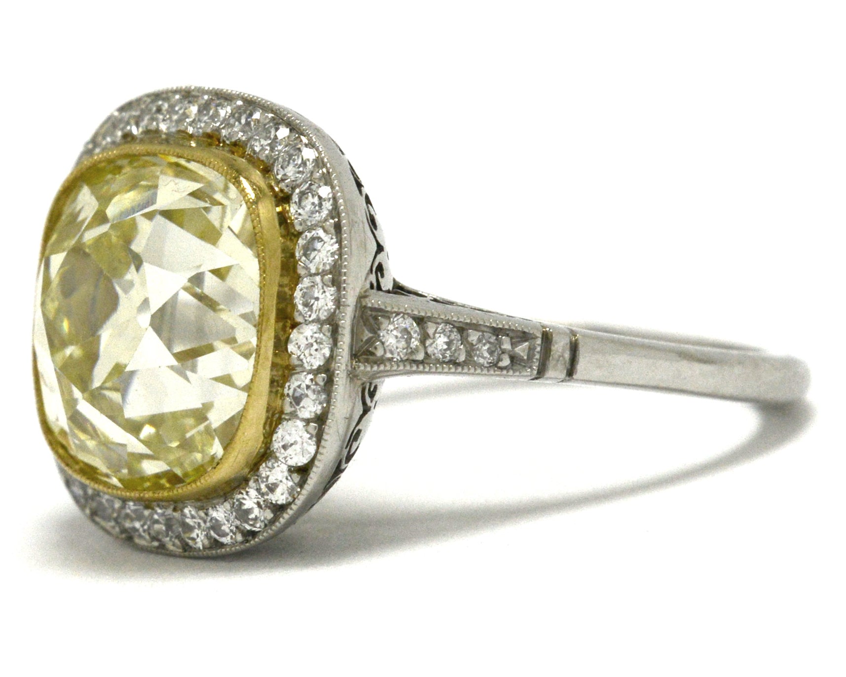 Light yellow 5 carat cushion diamond platinum engagement ring.