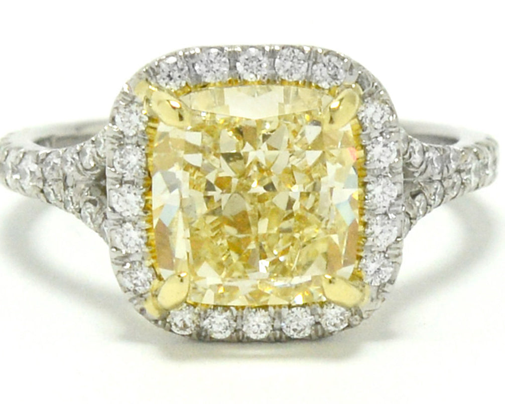 A cushion modified brilliant cut 3 carat yellow canary diamond target ring.
